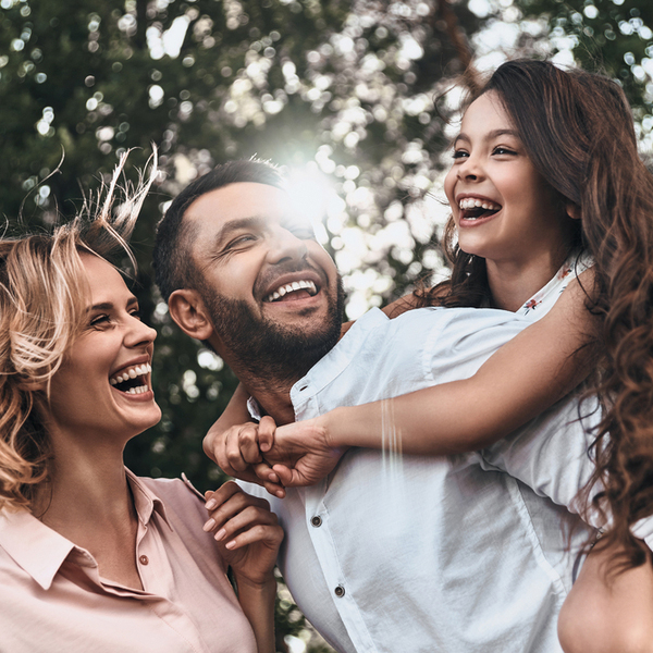 Family of Three Laughing Outdoors