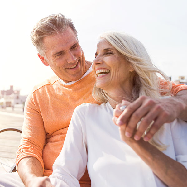 Older Couple Laughing on a Bench